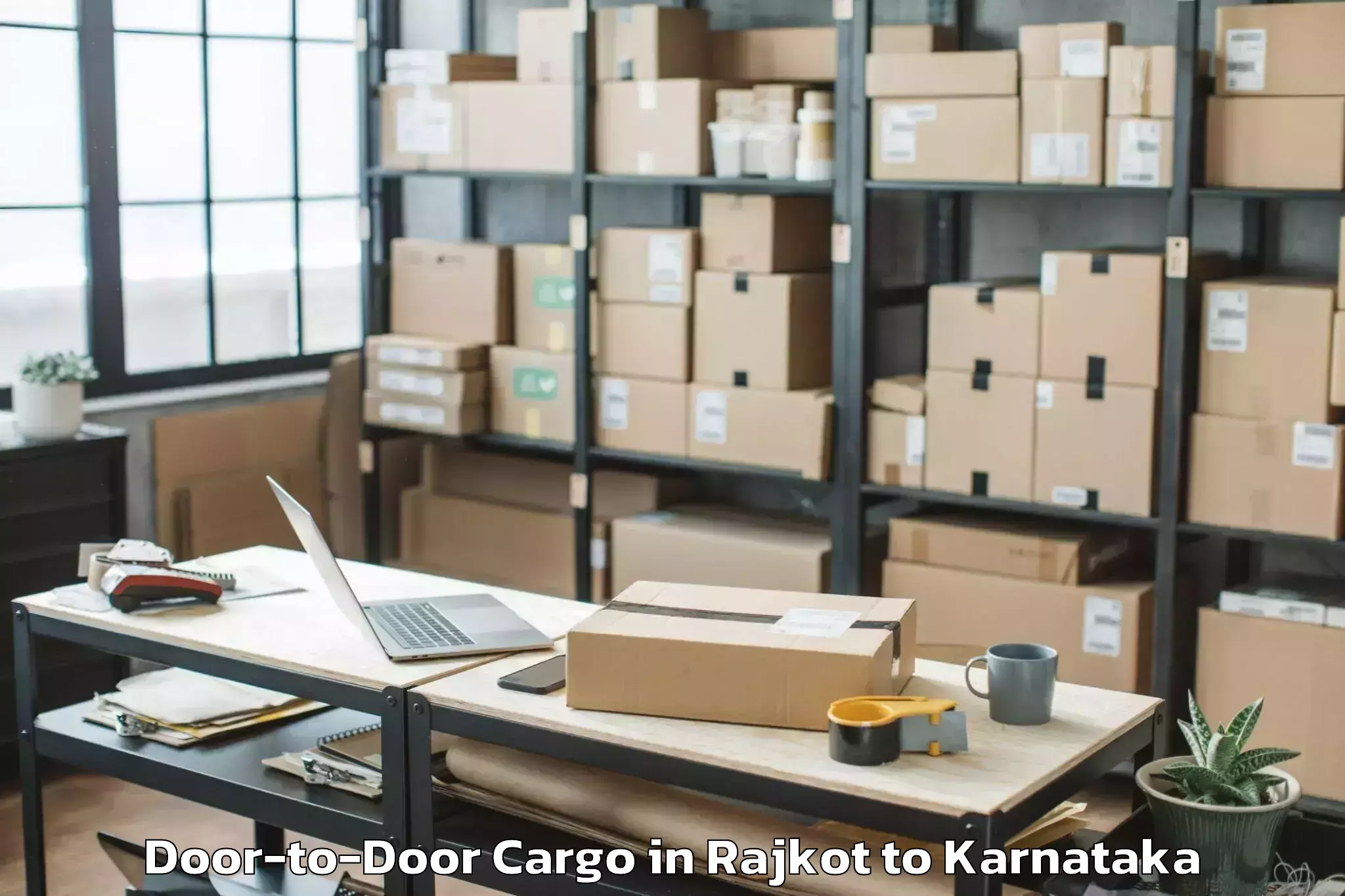 Rajkot to Karnataka State Law University Door To Door Cargo